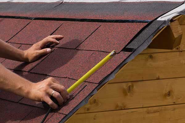 Roof Inspection roofer taking measurements