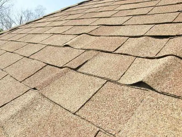 roof with shingles buckling